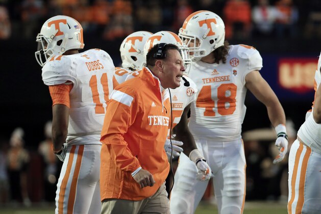 Tennessee head coach Butch Jones talks to his players in the second quarter of an NCAA college football game against Vanderbilt Saturday, Nov. 29, 2014, in Nashville, Tenn. (AP Photo/Mark Humphrey)