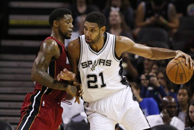 Oct 18, 2014; San Antonio, TX, USA; San Antonio Spurs power forward Tim Duncan (21) posts up against Miami Heat power forward Udonis Haslem (left) during the second half at AT&T Center. The Heat won 111-108 in overtime. Mandatory Credit: Soobum Im-USA TODAY Sports
