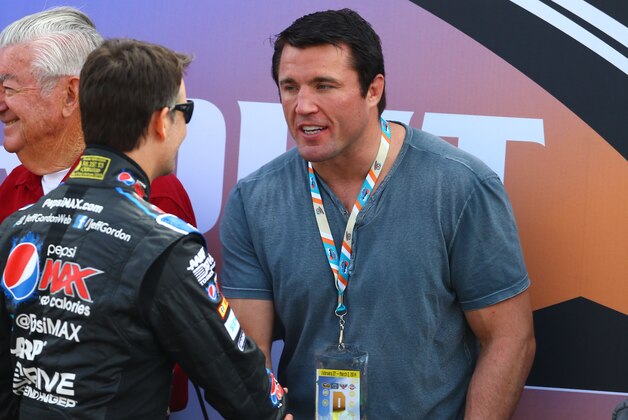 Mar 2, 2014; Avondale, AZ, USA; NASCAR Sprint Cup Series driver Jeff Gordon (left) greets UFC fighter Chael Sonnen prior to the The Profit on CNBC 500 at Phoenix International Raceway. Mandatory Credit: Mark J. Rebilas-USA TODAY Sports