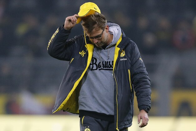 Dortmund's head coach Juergen Klopp lifts his hat after the German first division Bundesliga soccer match between Borussia Dortmund and VfL Wolfsburg in Dortmund, Germany, Wednesday, Dec. 17, 2014. (AP Photo/Frank Augstein)