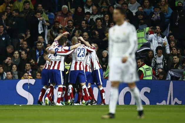 Atletico's Fernando celebrates his goal with teammates during a round of 16, second leg, Copa del Rey soccer match between Atletico de Madrid and Real Madrid at the Santiago Bernabeu stadium in Madrid, Spain, Thursday Jan. 15, 2015. (AP Photo/Andres Kudacki)