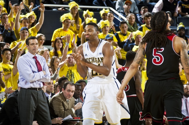 Nebraska head coach Tim Miles, left, watches Michigan guard Zak Irvin (21) and Nebraska guard Terran Petteway (5) react after a play in the second half of an NCAA college basketball game at Crisler Center in Ann Arbor, Mich., Tuesday, Jan. 27, 2015. Michigan won 58-44. (AP Photo/Tony Ding)
