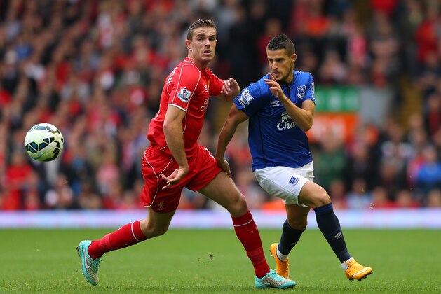 LIVERPOOL, ENGLAND - SEPTEMBER 27:  Kevin Mirallas of Everton goes past Jordan Henderson of Liverpool during the Barclays Premier League match between Liverpool and Everton at Anfield on September 27, 2014 in Liverpool, England.  (Photo by Alex Livesey/Getty Images)
