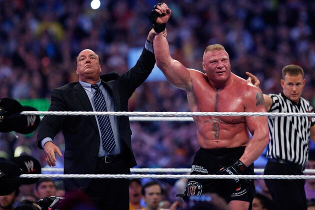 Paul Heyman, left, celebrates with Brock Lesnar after his win over the Undertaker  during Wrestlemania XXX at the Mercedes-Benz Super Dome in New Orleans on Sunday, April 6, 2014. (Jonathan Bachman/AP Images for WWE)