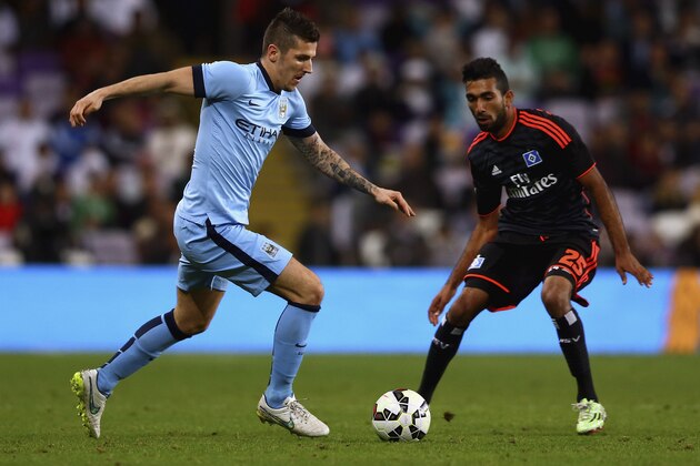 AL AIN, UNITED ARAB EMIRATES - JANUARY 21:  Stevan Jovetic of Manchester City controls the ball against Mohammad Gouaida of Hamburg during the friendly match between Hamburg SV and Manchester City at Hazza bin Zayed Stadium on January 21, 2015 in Al Ain, United Arab Emirates.  (Photo by Francois Nel/Getty Images)