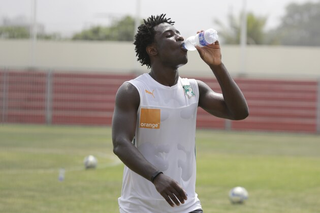 Ivory Coast player, Wilfried Bony, cool off with a bottle of water after a soccer  training session at La Paz Stadium in Malabo, Equatorial Guinea, Saturday, Jan. 17, 2015.  Yaya Toure sat out practice Saturday, three days before the Ivory Coast plays it opening match at the African Cup of Nations. The four-time African player of year stretched on the side as his teammates practiced at a small stadium in Malabo. The Ivory Coast opens play in Group D on Tuesday against Guinea at Estadio de Malabo. Mali will face Cameroon later that night. Toure, who plays for Manchester City, is a key player for both his country and his Premier League club. (AP Photo/Sunday Alamba)