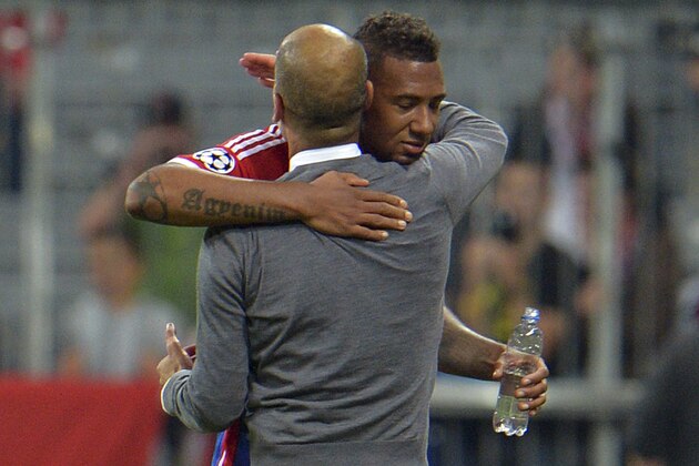 Bayern's Jerome Boateng, rear, hugs Bayern's head coach Pep Guardiola after winning the Champions League group E soccer match between Bayern Munich and Manchester City in Munich, Germany, Wednesday Sept.17,2014. (AP Photo/Kerstin Joensson)