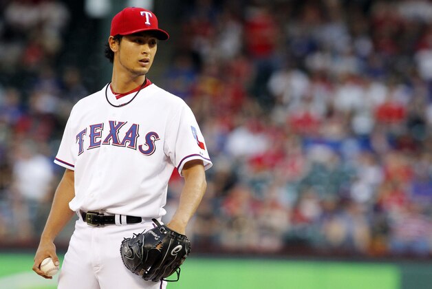 Apr 30, 2013; Arlington, TX, USA; Texas Rangers starting pitcher Yu Darvish (11) looks for a sign in the first inning against the Chicago White Sox at Rangers Ballpark in Arlington. Mandatory Credit: Tim Heitman-USA TODAY Sports
