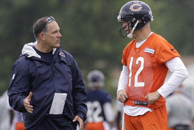 Chicago Bears quarterback coach Matt Cavanaugh, left, talks with quarterback Josh McCown during NFL football training camp Saturday, July 27, 2013, at Olivet Nazarene University in Bourbonnais, Ill. (AP Photo/Nam Y. Huh)