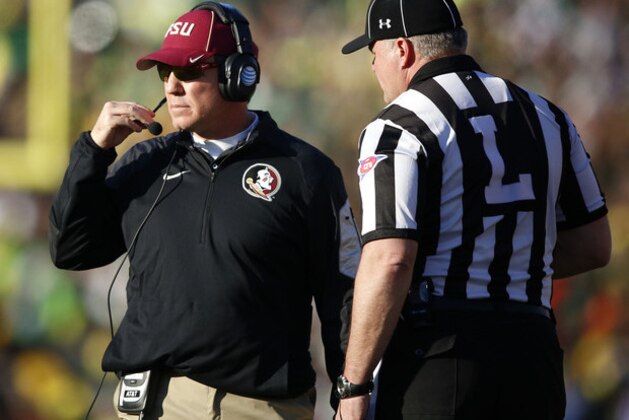 Florida State head coach Jimbo Fisher, left, talks with with an official while taking on Oregon in the Rose Bowl NCAA college football playoff semifinal, Thursday, Jan. 1, 2015 in Pasadena, Calif. Oregon defeated Florida State 59-20 to advance to the first ever NCAA football playoff championship game. (AP Photo/Doug Benc)