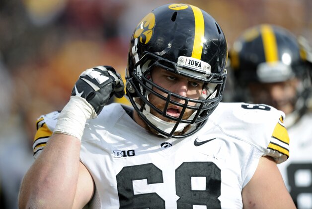 Iowa offensive lineman Brandon Scherff (68) watches from the sidelines during the third quarter of an NCAA college football game against Minnesota on Saturday, Nov. 8, 2014, in Minneapolis. Minnesota won 51-14. (AP Photo/Hannah Foslien)