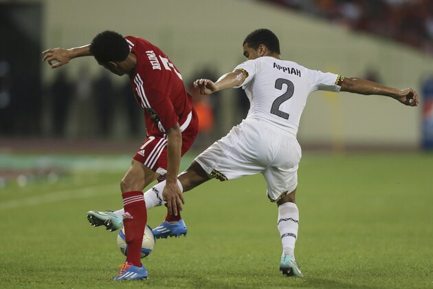 Ghana's Kwesi Appiah, right, in action with Equatorial Guinea's Reuban Belima, left, During their African Cup of Nations Semifinals soccer match at Estadio De Malabo, Equatorial Guinea, Thursday Feb. 5, 2015. (AP Photo/Sunday Alamba)