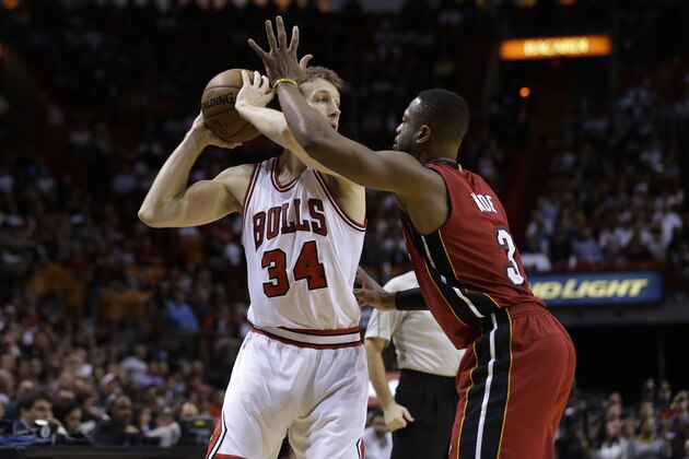 Chicago Bulls forward Mike Dunleavy (34) looks to pass as Miami Heat guard Dwyane Wade (3) defends in the second half of an NBA basketball game, Sunday, Dec. 14, 2014, in Miami. The Bulls defeated the Heat 93-75. (AP Photo/Lynne Sladky)