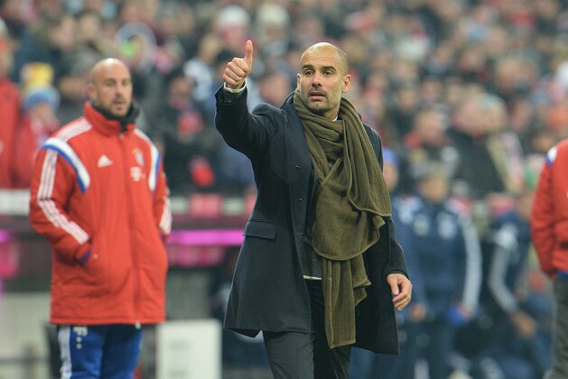 Munich head coach Pep Guardiola gestures during the  soccer match between FC Bayern Munich and FC Schalke in the Allianz Arena in Munich, Germany, on Tuesday, Feb. 3, 2015. (AP Photo/Kerstin Joensson)
