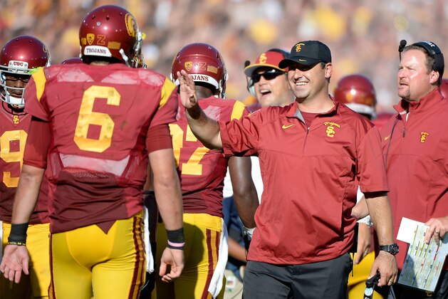 LOS ANGELES, CA - AUGUST 30:  Steve Sarkisian celebrates the touchdown of wide receiver Nelson Agholor #15 with quarterback Cody Kessler #6 to take a 21-0 lead over the Fresno State Bulldogs during the first quarter at Los Angeles Memorial Coliseum on August 30, 2014 in Los Angeles, California.  (Photo by Harry How/Getty Images)
