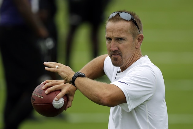 Baltimore Ravens assistant head coach Steve Spagnuolo throws a pass during a training camp practice, Thursday, July 24, 2014, at the team's practice facility in Owings Mills, Md. (AP Photo)