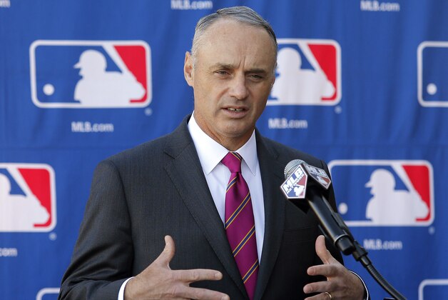 FILE - In a Jan. 15, 2015 file photo then Commissioner-elect Rob Manfred speaks during a news conference at the Major League Baseball owners meeting in Phoenix.   Monday morning, Jan. 26, 2015, was the first business day after Manfred succeeded Bud Selig and started a five-year term as commissioner. (AP Photo/Rick Scuteri, file)
