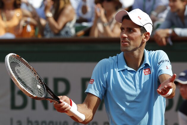 Serbia's Novak Djokovic gestures after missing a return during the final of the French Open tennis tournament against Spain's Rafael Nadal at the Roland Garros stadium, in Paris, France, Sunday, June 8, 2014.  (AP Photo/Michel Euler)