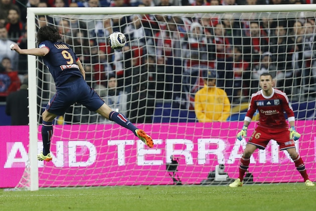 Paris Saint Germain's Edinson Cavani of Argentina, left, heads the ball to score past Olympic Lyonnais goalkeeper Anthony Lopes during the French League Cup Final soccer match at the Stade de France in Saint Denis, north of Paris, Saturday April 19, 2014. (AP Photo/Jacques Brinon)