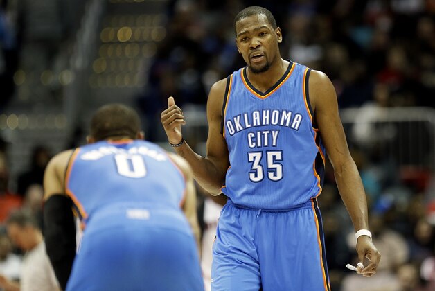 Oklahoma City Thunder's Kevin Durant, right, talks to teammate Russell Westbrook during the second quarter of an NBA basketball game against the Atlanta Hawks, Friday, Jan. 23, 2015, in Atlanta. The Hawks won 103-93. (AP Photo/David Goldman)
