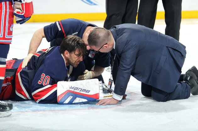 NEW YORK, NY - JANUARY 31:  Henrik Lundqvist #30 of the New York Rangers is attended to by members of the medical staff after being hit with a high stick against the Carolina Hurricanes at Madison Square Garden on January 31, 2015 in New York City. (Photo by Jared Silber/NHLI via Getty Images)
