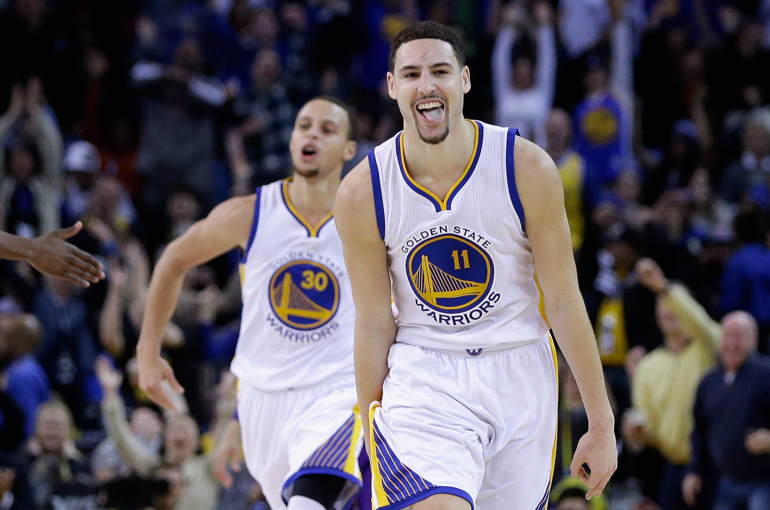 OAKLAND, CA - JANUARY 23:  Klay Thompson #11 of the Golden State Warriors reacts after he made a three-point basket in the third quarter of their game against the Sacramento Kings at ORACLE Arena on January 23, 2015 in Oakland, California. Thompson scored 37 points in the third quarter to set a NBA record. NOTE TO USER: User expressly acknowledges and agrees that, by downloading and or using this photograph, User is consenting to the terms and conditions of the Getty Images License Agreement.  (Photo by Ezra Shaw/Getty Images)