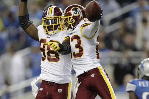 Washington Redskins cornerback DeAngelo Hall, right,  celebrates with Brian Orakpo (98) after intercepting a pass from Detroit Lions quarterback Matthew Stafford in the end zone in the first quarter of their NFL football game in Detroit, Sunday, Oct. 31, 2010.  (AP Photo/Paul Sancya)