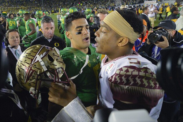 Oregon quarterback Marcus Mariota, center left, greets Florida State quarterback Jameis Winston after Oregon's win in the Rose Bowl NCAA college football playoff semifinal, Thursday, Jan. 1, 2015, in Pasadena, Calif. (AP Photo/Mark J. Terrill)