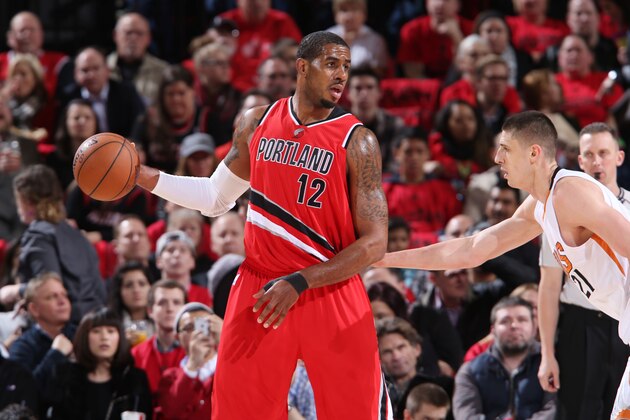 PORTLAND, OR - FEBRUARY 5: LaMarcus Aldridge #12 of the Portland Trail Blazers defends the ball against the Phoenix Suns during the game on February 5, 2015 at the Moda Center Arena in Portland, Oregon. NOTE TO USER: User expressly acknowledges and agrees that, by downloading and or using this photograph, user is consenting to the terms and conditions of the Getty Images License Agreement. Mandatory Copyright Notice: Copyright 2015 NBAE (Photo by Sam Forencich/NBAE via Getty Images)