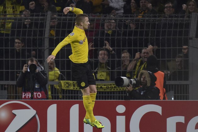 Dortmund's Marco Reus celebrates after scoring the opening goal during the Champions League group D soccer match between Borussia Dortmund and Galatasaray Istanbul in Dortmund, Germany, Tuesday, Nov.4,,2014. (AP Photo/Martin Meissner)