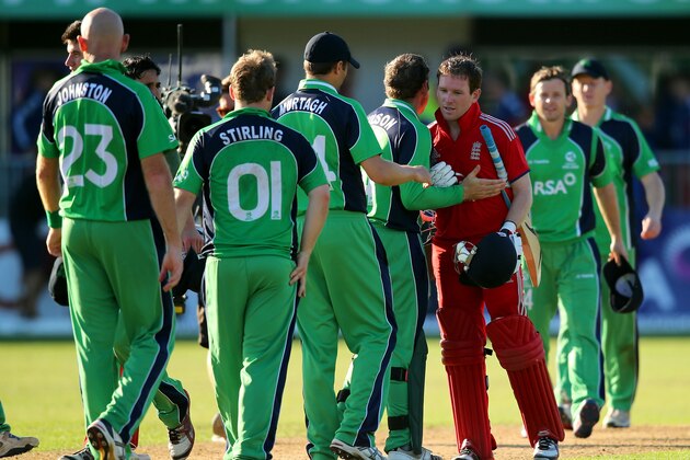 MALAHIDE, IRELAND - SEPTEMBER 03:  Eoin Morgan of England is congratulated by the Irish team after hitting the winning runs in the RSA Challenge One Day International match between Ireland and England on September 3, 2013 in Malahide, Ireland.  (Photo by Clive Rose/Getty Images)