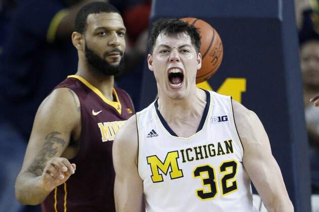 ANN ARBOR, MI - JANUARY 10: Ricky Doyle #32 of the Michigan Wolverines celebrates after scoring against Maurice Walker #15 of the Minnesota Golden Gophers during the second half at Crisler Arena on January 10, 2015 in Ann Arbor, Michigan. Michigan defeated Minnesota 62-57. (Photo by Duane Burleson/Getty Images)