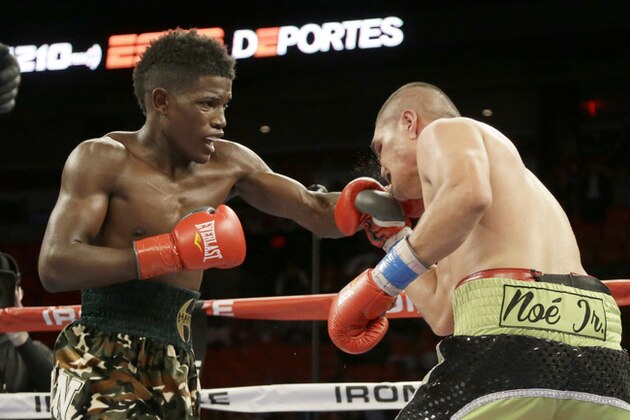 Erickson Lubin, left, fights against Noe Bolanos during a boxing match, Thursday, July 10, 2014 in Miami. Lubin defeated Bolanos by unanimous decision in eight rounds. (AP Photo/Wilfredo Lee)
