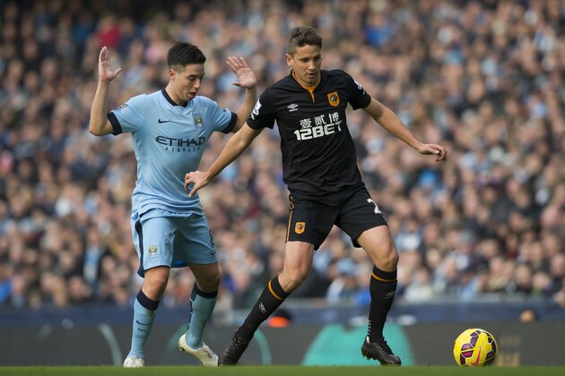 Hull's Gaston Ramirez, right, keeps the ball from Manchester City's Samir Nasri during the English Premier League soccer match between Manchester City and Hull at the Etihad Stadium, Manchester, England, Saturday Feb. 7, 2015. (AP Photo/Jon Super)