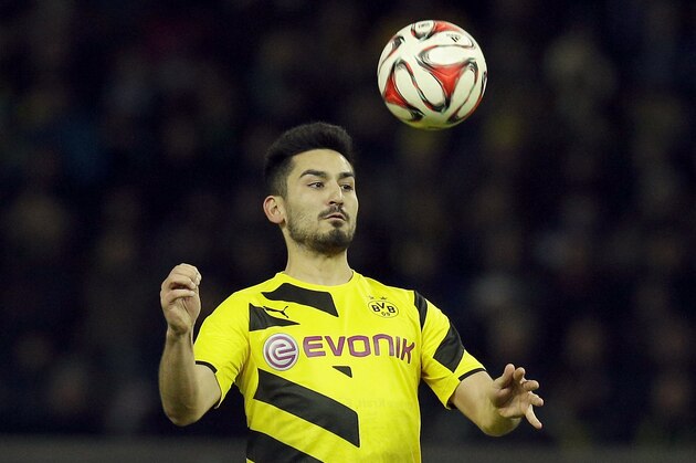 Dortmund's Ilkay Gundogan plays the ball during the German Bundesliga soccer match between Hertha BSC Berlin and Borussia Dortmund at the Olympia stadium in Berlin, Germany, Saturday, Dec. 13, 2014. Berlin defeated Dortmund by 1-0.(AP Photo/Michael Sohn)