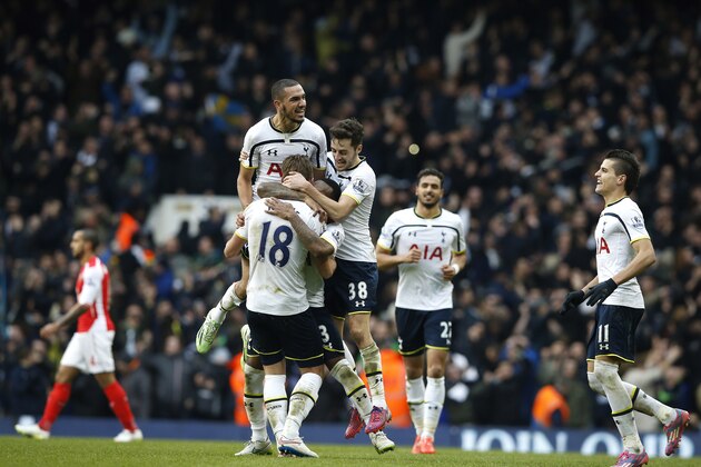 Tottenham’s Harry Kane is mobbed by his teammates after the English Premier League soccer match between Tottenham Hotspur and Arsenal at the White Hart Lane stadium in London, Saturday, Feb. 7, 2015. Kane scored a brace of goals as Spurs won 2-1. (AP Photo/Alastair Grant)
