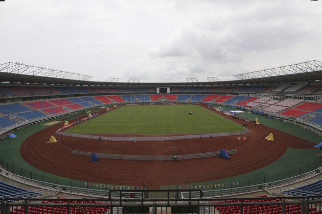 Stadium workers level the grass ahead of the African Cup of Nations Finals soccer match between Ivory Coast and Ghana on Sunday, at the Estadio De Bata, Equatorial Guinea, Saturday Feb. 7, 2015. (AP Photo/Sunday Alamba)
