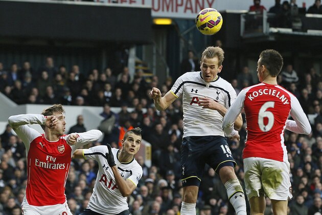 Tottenham’s Harry Kane, second right, heads the ball to score his side's second goal during the English Premier League soccer match between Tottenham Hotspur and Arsenal at the White Hart Lane stadium in London, Saturday, Feb. 7, 2015. (AP Photo/Alastair Grant)