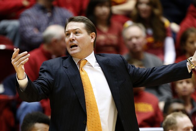 AMES, IA - JANUARY 6:  Head coach Travis Ford of the Oklahoma State Cowboys coaches from the bench in the first half of play against the Iowa State Cyclones at Hilton Coliseum on January 6, 2015 in Ames, Iowa. (Photo by David Purdy/Getty Images)