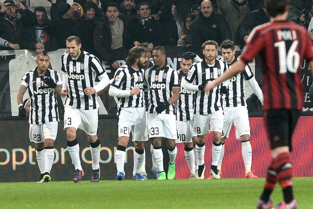 Juventus' players celebrate after Carlos Tevez scored his side's first goal, during a Serie A soccer match between Juventus and  Milan at the Juventus stadium, in Turin, Italy, Sunday, Feb. 7, 2015. (AP Photo/Massimo Pinca)