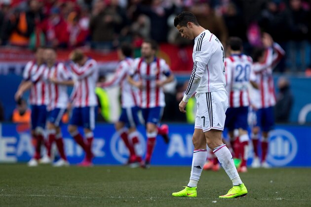 MADRID, SPAIN - FEBRUARY 07:  Cristiano Ronaldo of Real Madrid CF reacts defeated as behind Mario Mandzukic of Atletico de Madrid celebrates scoring their fourth goal with teammates during the La Liga match between Club Atletico de Madrid and Real Madrid CF at Vicente Calderon Stadium on February 7, 2015 in Madrid, Spain.  (Photo by Gonzalo Arroyo Moreno/Getty Images)