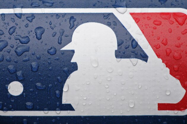 Rain drops accumulate on a Major League Baseball logo on the ad board behind the home plate before Game 5 of the American League baseball championship series between the Boston Red Sox and the Detroit Tigers, Thursday, Oct. 17, 2013, in Detroit. (AP Photo/Matt Slocum)