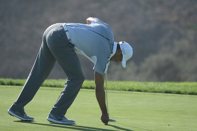 LA JOLLA, CA - FEBRUARY 05:  Tiger Woods picks up his ball after withdrawing from the tournament on the third hole of the north course during the first round of the Farmers Insurance Open at Torrey Pines Golf Course on February 5, 2015 in La Jolla, California.  (Photo by Donald Miralle/Getty Images)