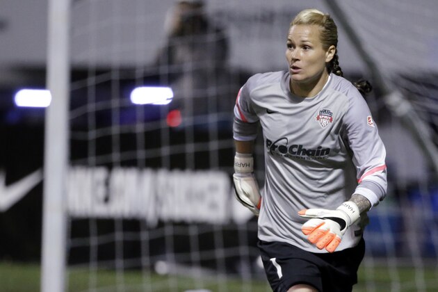 Washington Spirit goalie Ashlyn Harris in action against the Seattle Reign FC in the first half of a NWSL semifinal soccer match Sunday, Aug. 24, 2014, in Seattle. (AP Photo/Elaine Thompson)