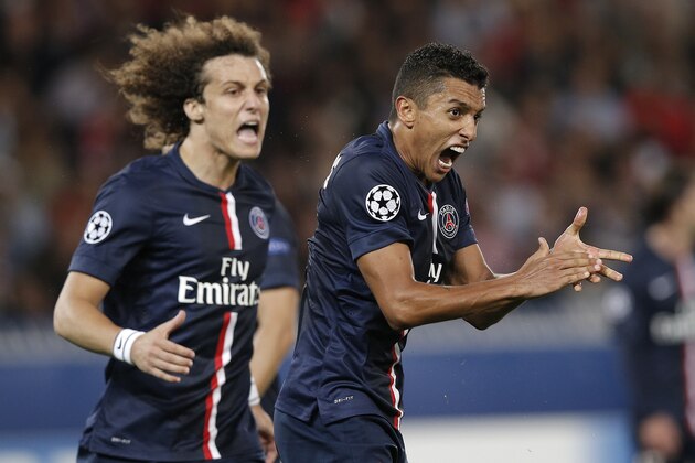 PSG's Marquinhos, right, and David Luiz react after Barcelona failed to score during the Champions League soccer match between PSG and Barcelona, at the Parc des Princes stadium, in Paris, Tuesday, Sept. 30, 2014. (AP Photo/Christophe Ena)