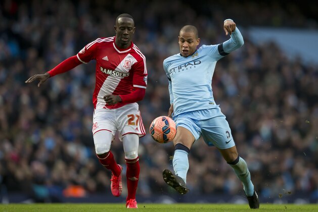 Manchester City's Fernando, right, fights for the ball against Middlesbrough's Albert Adomah during the English FA Cup fourth round soccer match between Manchester City and Middlesbrough at the Etihad Stadium, Manchester, England, Saturday, Jan. 24, 2015. (AP Photo/Jon Super)