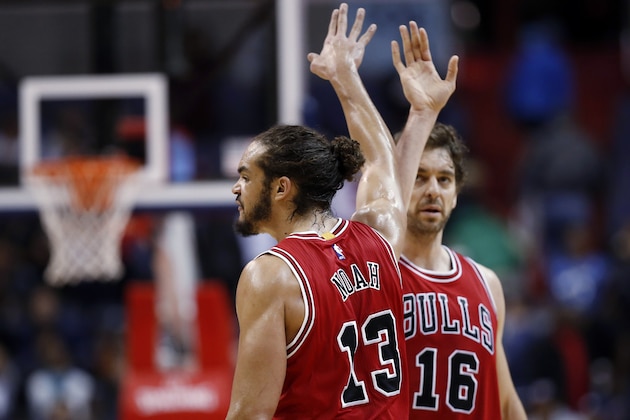 Chicago Bulls center Joakim Noah (13) celebrates with forward Pau Gasol (16) in the last seconds of an NBA basketball game against the Washington Wizards, Tuesday, Dec. 23, 2014, in Washington. The Bulls won 99-91. (AP Photo/Alex Brandon)