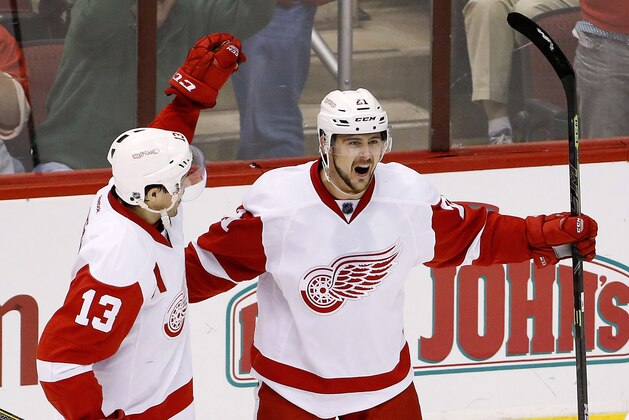 Detroit Red Wings' Tomas Tatar (21), of the Czech Republic, celebrates his goal against the Arizona Coyotes with Pavel Datsyuk (13), of Russia, during the third period of an NHL hockey game Saturday, Feb. 7, 2015, in Glendale, Ariz.  The Red Wings defeated the Coyotes 3-1. (AP Photo/Ross D. Franklin)