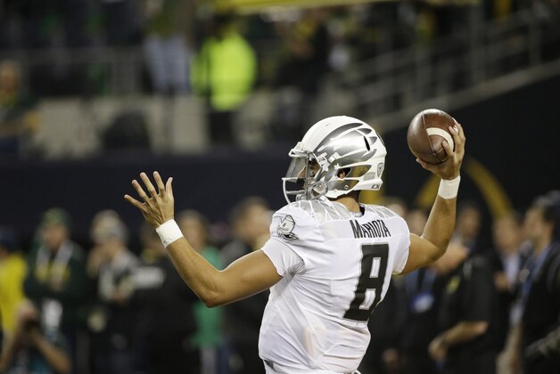Oregon's Marcus Mariota (8) warms up before the NCAA college football playoff championship game against Ohio State Monday, Jan. 12, 2015, in Arlington, Texas. (AP Photo/David J. Phillip)