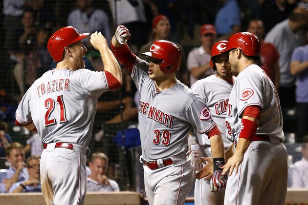 Cincinnati Reds' Devin Mesoraco (39) celebrates his grand slam off Chicago Cubs relief pitcher Hector Rondon with Todd Frazier (21) Joey Votto, right, and Billy Hamilton, during the ninth inning of a baseball game Monday, June 23, 2014, in Chicago. All four scored on the play. (AP Photo/Charles Rex Arbogast)